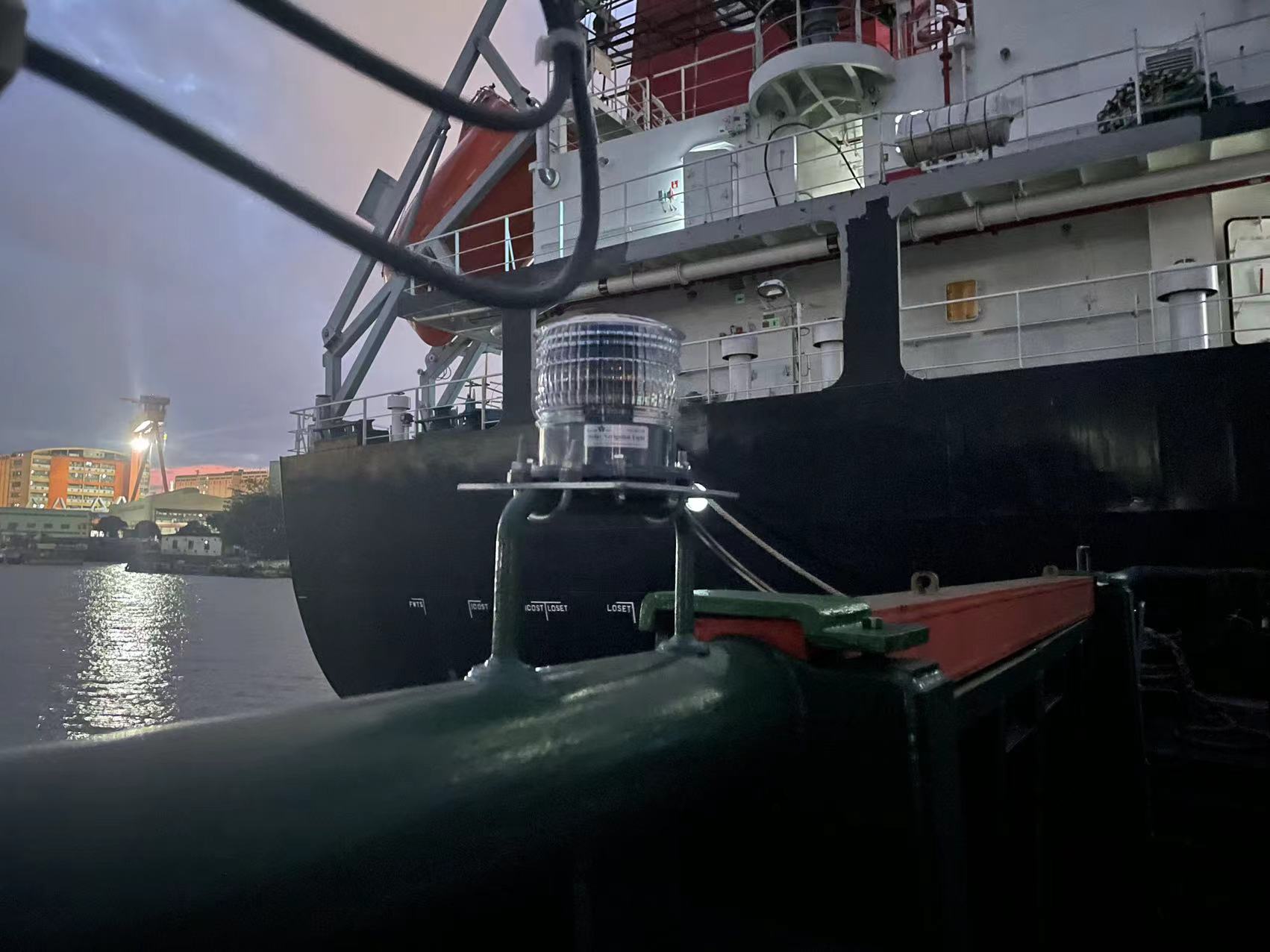Solar LED barge navigation light installed on the stern of a vessel at dusk